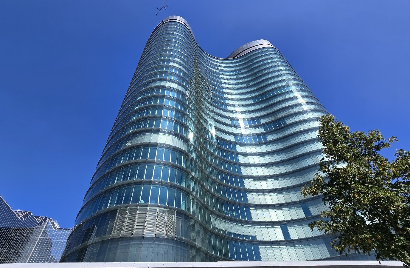 The curved, structural headquarters building of a major Dutch bank in Utrecht.